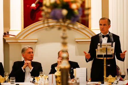 Britain's Chancellor of the Exchequer Philip Hammond listens to the Governor of the Bank of England Mark Carney's speech at the Annual Mansion House dinner in London, Britain, June 21 2018. REUTERS/Henry Nicholls