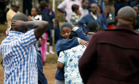 A student embraces her parent following a fire which burnt down one dormitory of Moi Girls school in Nairobi, Kenya September 2, 2017. REUTERS/Baz Ratner