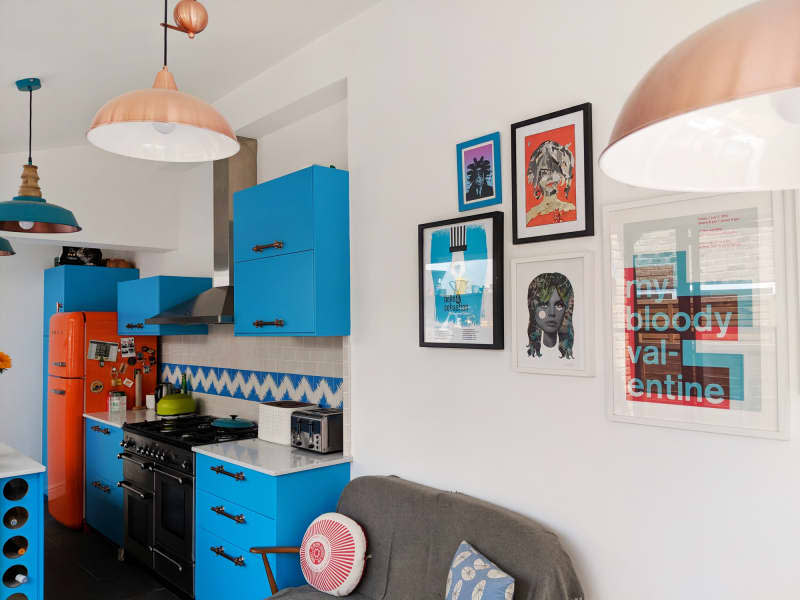 A blue and orange galley kitchen