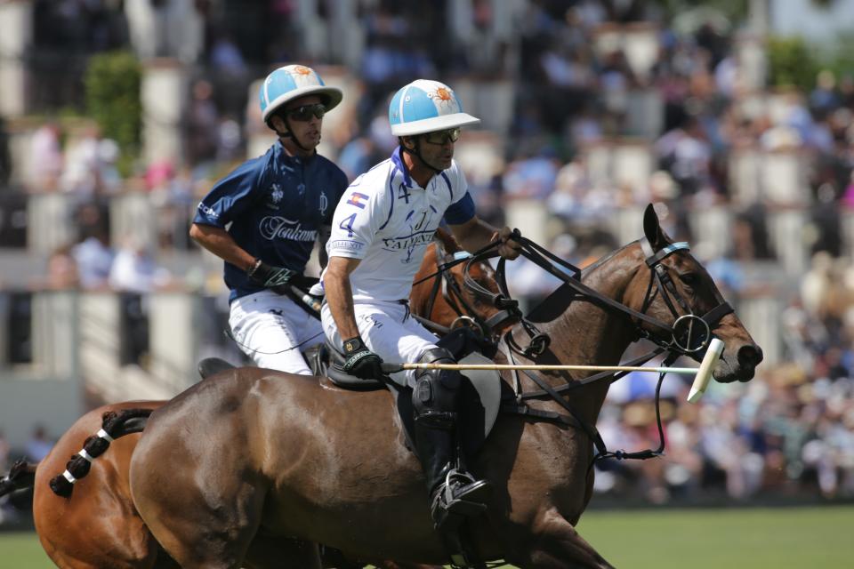 Father and son, Adolfo Cambiaso (right) and Poroto Cambiaso, battle during Sunday's 50th USPA Gold Cup in Wellington.