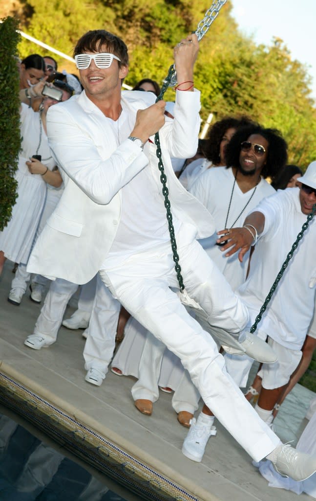 Ashton Kutcher swings at one of Diddy’s White Parties — hosted in Beverly Hills in 2009. The event intended to raise awareness for malaria. Getty Images/Getty Images for Bl