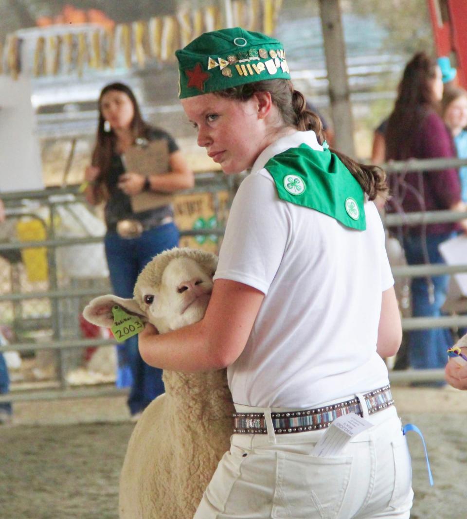 A 4-H member shows her sheep at the Siskiyou Golden Fair on Aug. 12, 2021. This year's Junior Livestock Auction is moving to the Jackson County Expo in Central Point, Oregon, because the Siskiyou Golden Fair grounds in being used as a fire camp for the McKinney Fire.