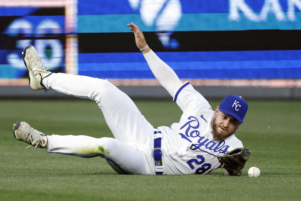 Kansas City Royals center fielder Kyle Isbel is unable to catch a fly ball by Texas Rangers' Ezequiel Duran during the fourth inning of a baseball game in Kansas City, Mo., Tuesday, April 18, 2023. Duran had an RBI single on the play. (AP Photo/Colin E. Braley)