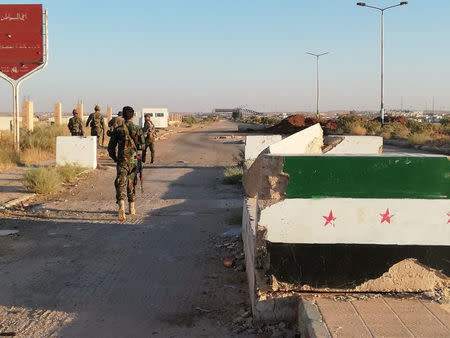 Syrian forces of President Bashar al Assad are seen in the Nassib border crossing with Jordan in Deraa, Syria July 6, 2018. Hezbollah Media/Handout via Reuters