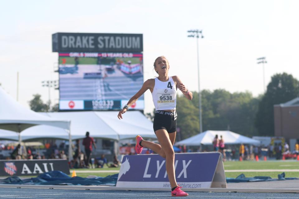 Sydney Johnson reacts upon crossing the finish line Saturday to win the 13-year-old division of the girls 3,000-meter run in a meet-record 10:03.33 at the AAU Junior Olympic Games.