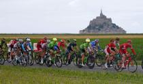 Cycling - The Tour de France cycling race - The 188-km (117 miles) 1st stage from Mont Saint-Michel to Utah Beach Sainte-Marie-du-Mont, France - 02/07/2016 - The pack of riders cycle near the Mont Saint-Michel. REUTERS/Juan Medina