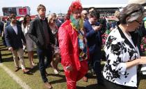 <p>Pictured: Punters brave wild weather as Melbourne Cup festivities get underway</p>