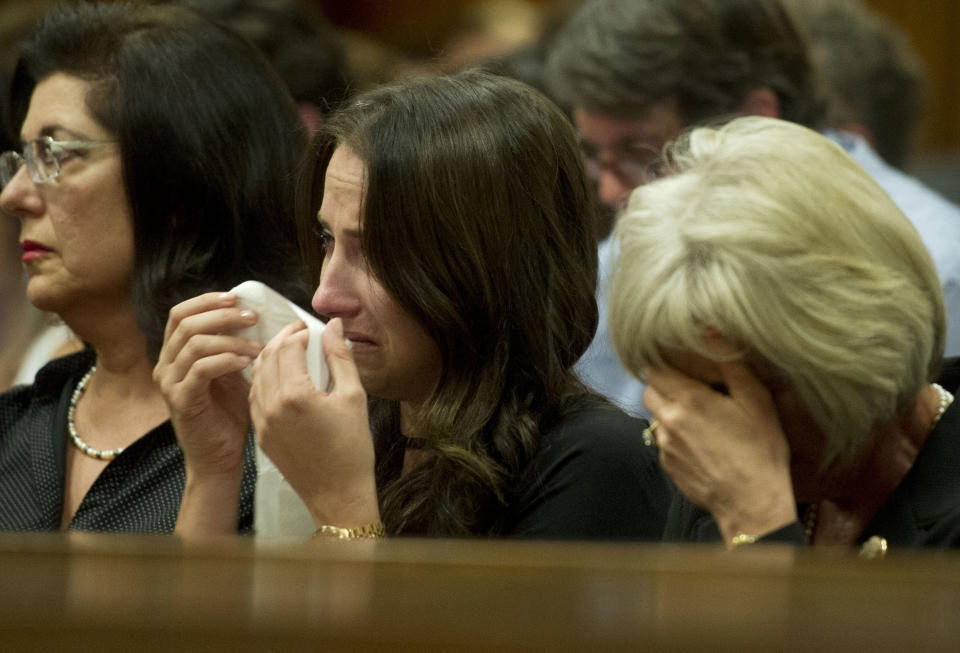 Sister Aimee Pistorius, center, and aunt Lois Pistorius, right, listen to Oscar Pistorius giving evidence in his murder trial in court in Pretoria, South Africa, Monday, April 7, 2014. Pistorius is charged with murder for the shooting death of his girlfriend Reeva Steenkamp, on Valentines Day 2013. (AP Photo/Deaan Vivier, Pool)