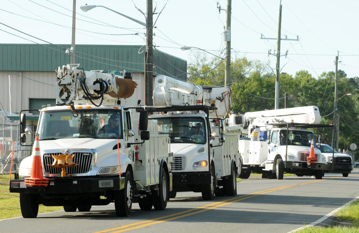 JEA crews and trucks head out to assist residents and businesses with power outages in this file photo.