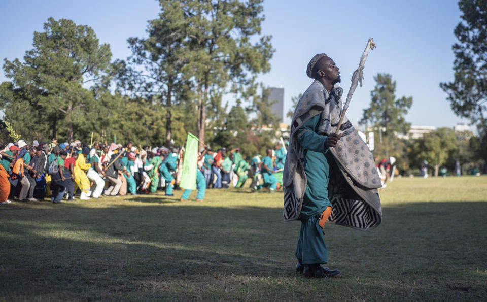 Striking miners protest for higher wages at the Union Buildings, in Pretoria, South Africa, Tuesday, May 24, 2022 as German Chancellor Olaf Scholz meets with South African President Cyril Ramaphosa on a one-day visit to the country. (AP Photo)