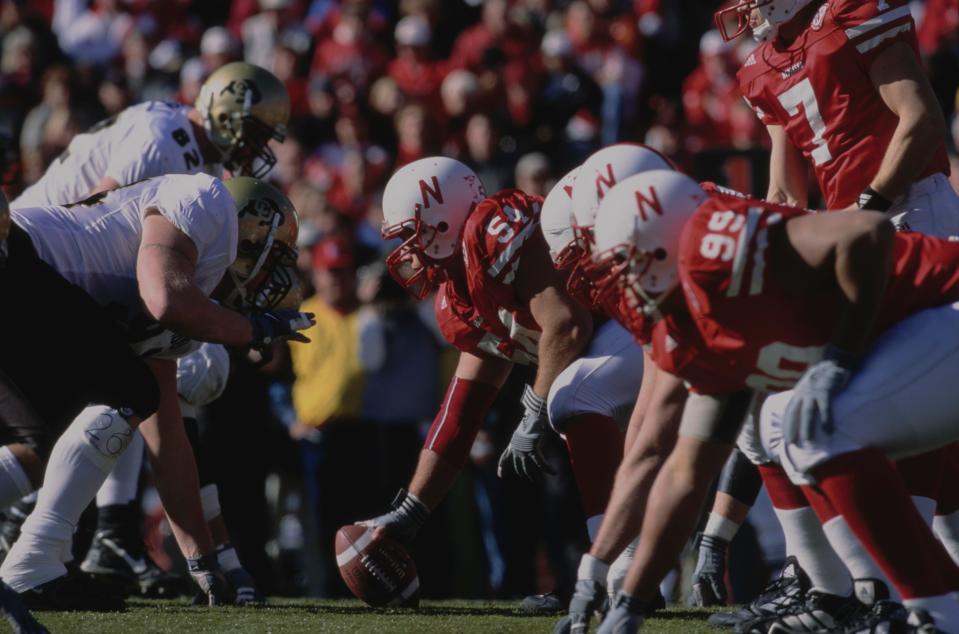 Dominic Raiola #54, Center and Outside Linebacker for the University of Nebraska Cornhuskers prepares to snap the football on the line of scrimmage during the NCAA Big 12 Conference college football game against the University of Colorado Buffaloes on 24th November 2000 at the Memorial Stadium in Lincoln, Nebraska, United States. Nebraska won the game 34-32. (Photo by Tom Hauck/Getty Images)