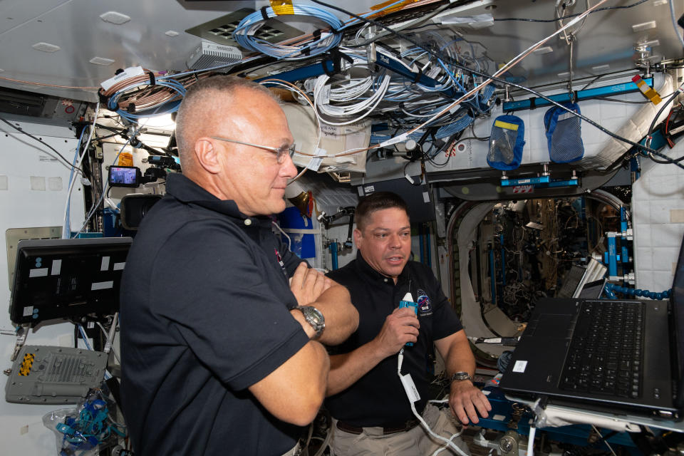 NASA astronauts Doug Hurley (foreground) and Bob Behnken, who flew to the International Space Station for SpaceX's Demo-2 mission, brief mission controllers about their experience in SpaceX's new Crew Dragon spacecraft, on June 1, 2020.