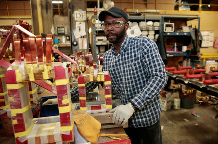 Sub-assembly worker Eric Mosley works on the sub-assembly of transformers at the RoMan Manufacturing plant in Grand Rapids, Michigan, U.S. December 12, 2018. Picture taken December 12, 2018. REUTERS/Rebecca Cook