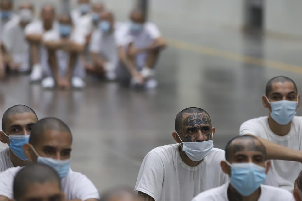 Inmates attend class on social behavior during a press tour of the Terrorism Confinement Center, a mega-prison in Tecololuca, El Salvador, Thursday, Oct. 12, 2023. Inmates wear masks as a precaution to not spread COVID-19. (AP Photo/Salvador Melendez)