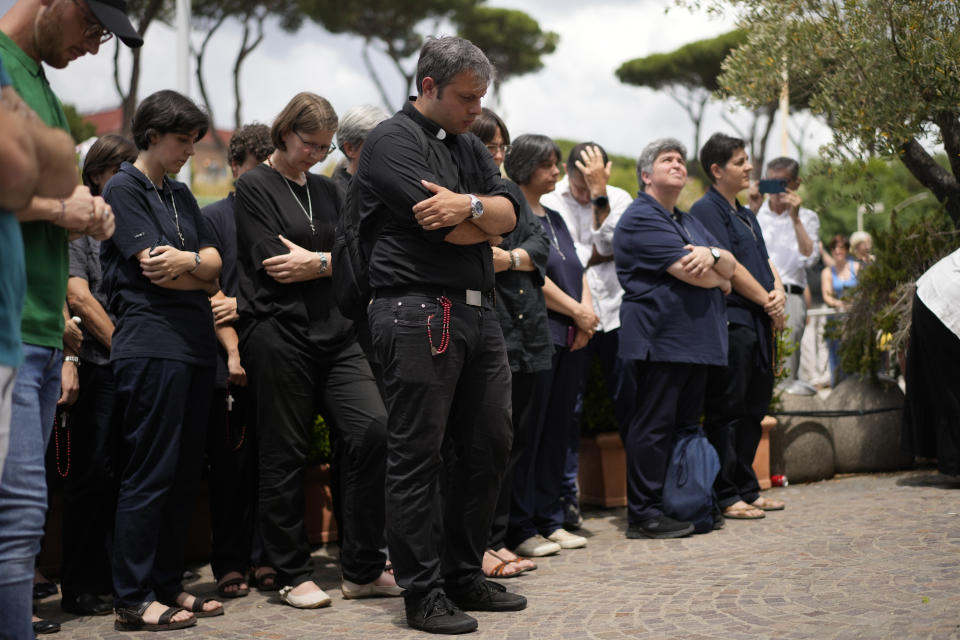 Faithful say the Sunday Angelus prayer in front of the windows of the Agostino Gemelli University Polyclinic in Rome, Sunday, June 11, 2023 wher Pope Francis is recovering from the abdominal surgery he underwent on Wednesday. (AP Photo/Andrew Medichini)