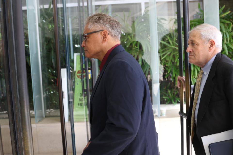 Former Honolulu police chief Louis Kealoha, left, walks into federal court in Honolulu on Wednesday, May 22, 2019. A trial for what has been described as the biggest corruption case in Hawaii history began Wednesday for Kealoha and his former city prosecutor wife, Katherine Kealoha. The two are accused of conspiring to frame Katherine Kealoha's uncle for a crime he did not commit. The Kealoha's were indicted on charges including conspiracy and obstruction. Federal authorities began investigating the two in 2015 and both stepped down from their jobs as the probe deepened. (AP Photo/Caleb Jones)