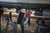 A person waits to receive a COVID-19 vaccination on a train parked at the Swartkops railroad yard outside Gqeberha, South Africa, Thursday Sept. 23, 2021. South Africa has sent a train carrying COVID-19 vaccines into one of its poorest provinces to get doses to areas where healthcare facilities are stretched. The vaccine train, named Transvaco, will go on a three-month tour through the Eastern Cape province and stop at seven stations for two weeks at a time to vaccinate people. (AP Photo/Jerome Delay)