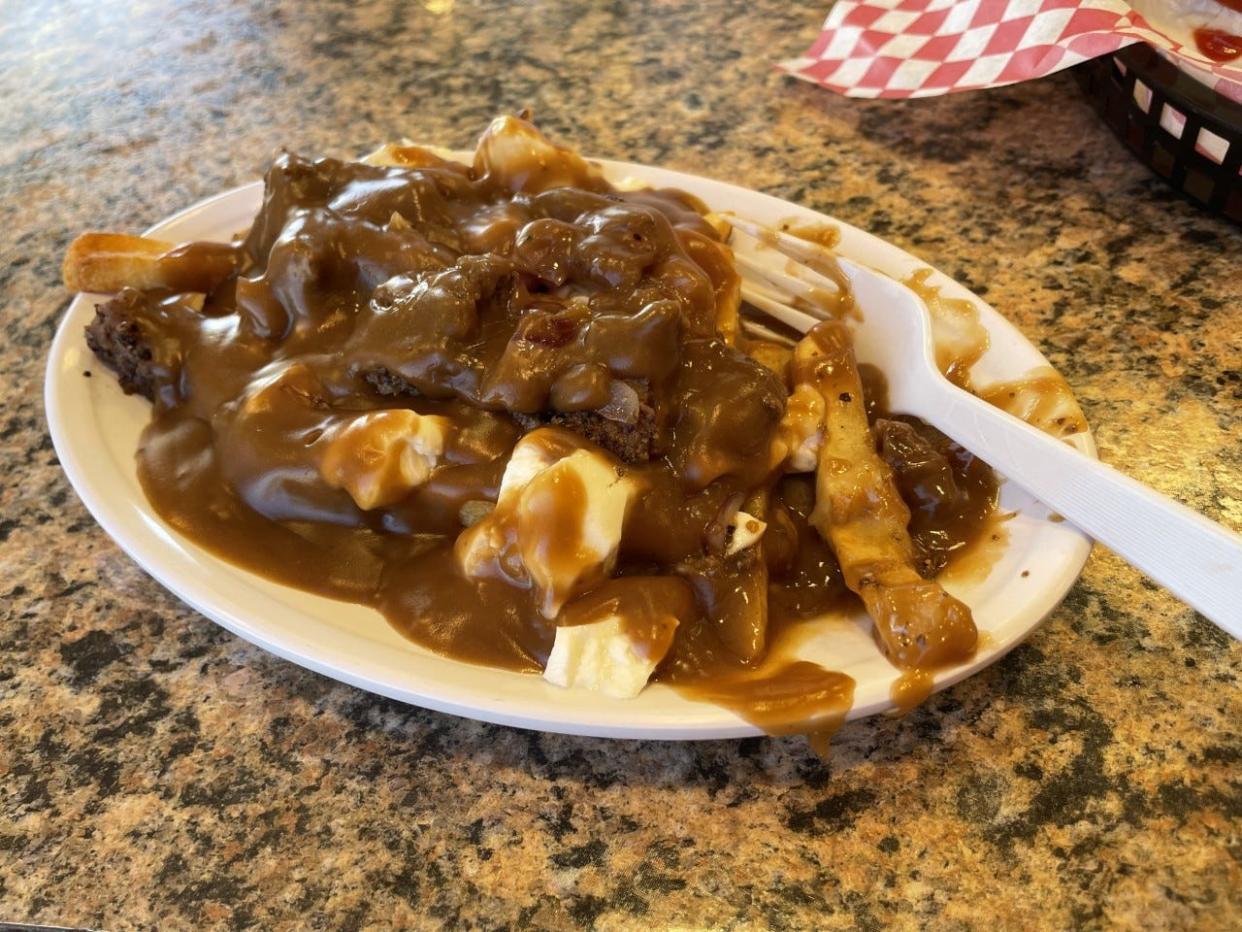 The Cattleman's Poutine, a snack food of fries and cheese curds topped with ground steak and brown gravy, is a popular menu item at Deep South Cheese and Grill in Dearing, Ga. Photo taken Oct. 20, 2022.