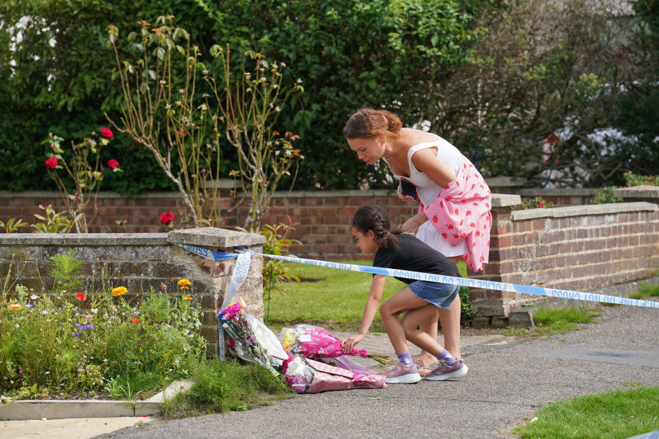 People lay flowers outside a property on Hammond Road in Woking, Surrey, where a 10-year-old girl was found dead after officers were called to the address on Thursday following a concern for safety. Picture date: Friday August 11, 2023. (Photo by Jonathan Brady/PA Images via Getty Images)