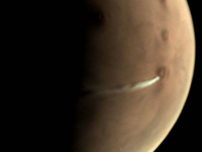 A picture shows an elongated cloud near the equator of Mars.