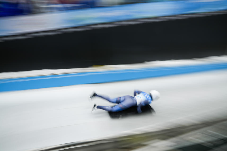 Kelly Curtis, of United States, slides during the women's skeleton run 2 at the 2022 Winter Olympics, Friday, Feb. 11, 2022, in the Yanqing district of Beijing. (AP Photo/Pavel Golovkin)