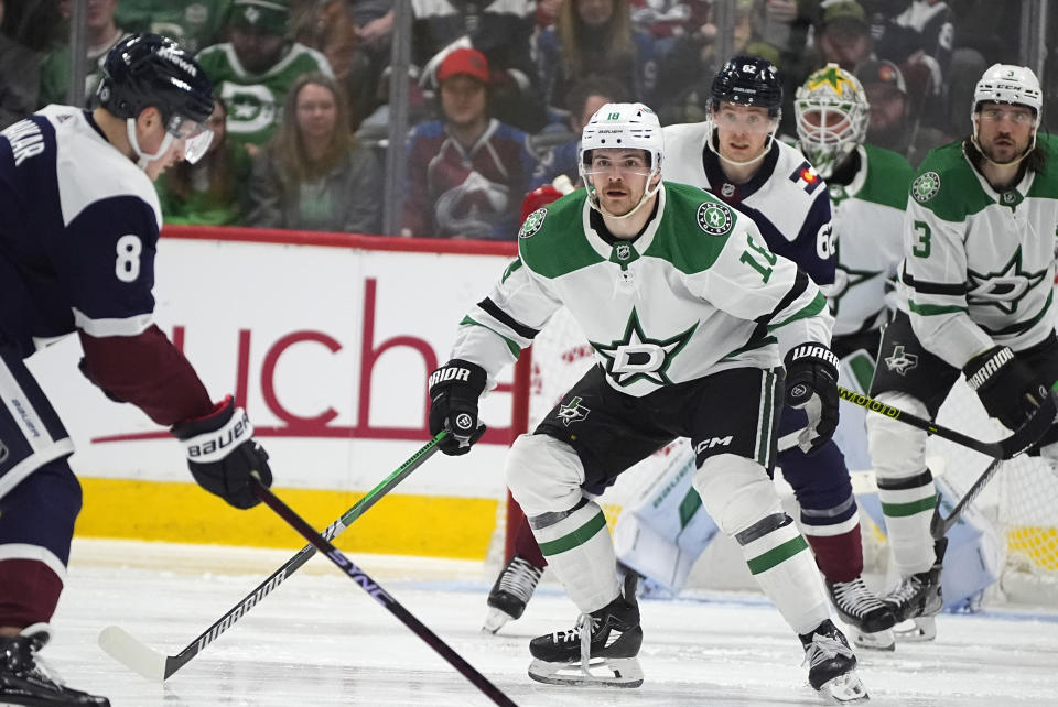 Dallas Stars center Sam Steel, right, drops back to block a shot by Colorado Avalanche defenseman Cale Makar (8) in the second period of an NHL hockey game Sunday, April 7, 2024, in Denver. (AP Photo/David Zalubowski)