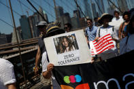 <p>A protest image is carried by a demonstrator as people cross the Brooklyn Bridge during “Keep Families Together” march to protest Trump administration’s immigration policy in New York, June 30, 2018. (Photo: Shannon Stapleton/Reuters) </p>