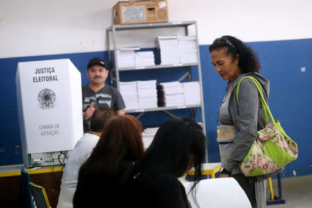 Brazilians arrive at the Ayrton Senna school set up as a polling station to cast their votes in the presidential election, in Rio de Janeiro, Brazil October 7, 2018. REUTERS/Sergio Moraes