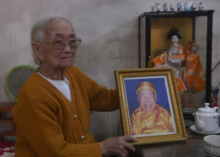 Nguyen Thi Xuan, 94, the Vietnamese wife of a former Japanese soldier, holds a framed portrait of her husband Shimizu at her home on the outskirts of Hanoi