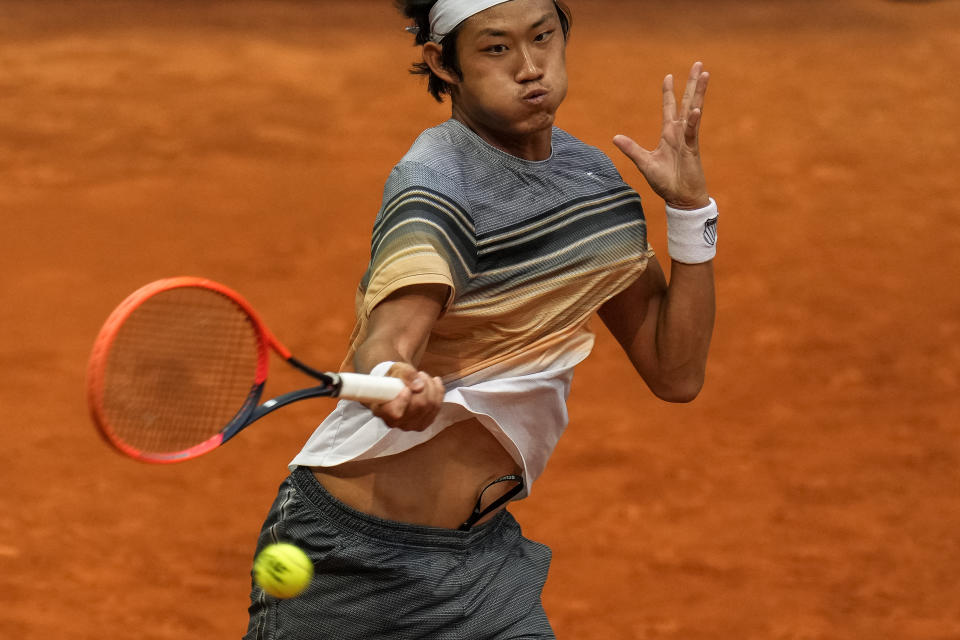 Zhang Zhizhen of China returns the ball against Taylor Fritz, of the United States, during their match at the Madrid Open tennis tournament in Madrid, Spain, Tuesday, May 2, 2023. (AP Photo/Manu Fernandez)