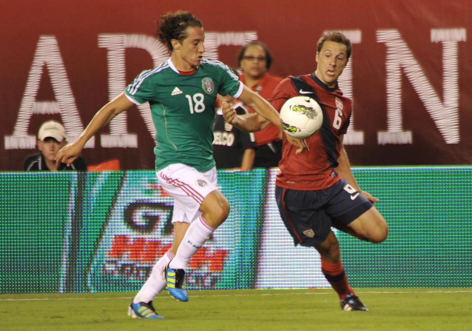 Andres Guardado (L) of Team Mexico vies for the ball with Steve Cherundolo (R) of Team USA in the first half of their international friendly match at Lincoln Financial Field in Philadelphia on August 10, 2011.