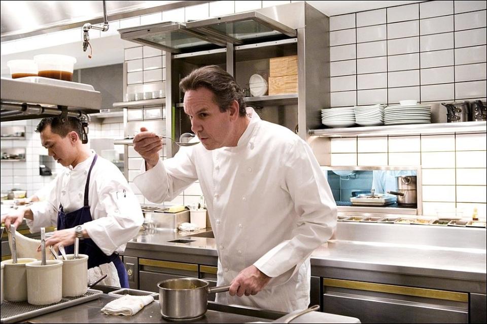 Thomas Keller tasting a sauce in the kitchen