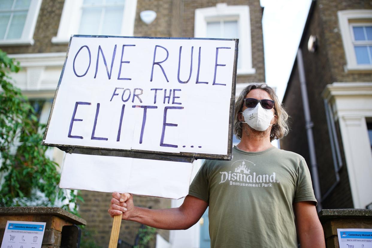 A protester outside Dominic Cummings' North London home: PA