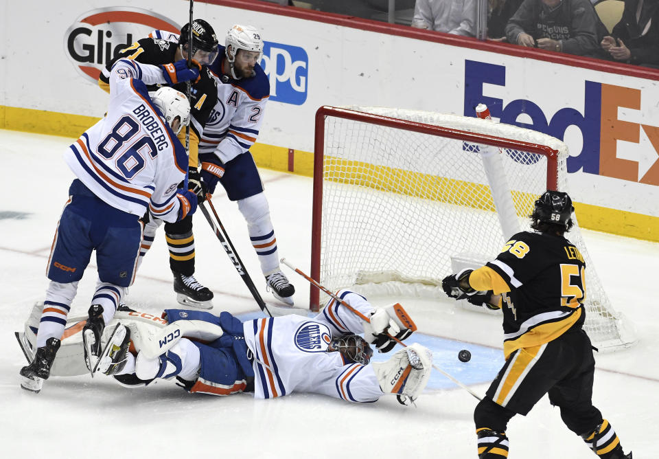 Pittsburgh Penguins defenseman Kris Letang (58) shoots and scores on Edmonton Oilers goalie Stuart Skinner (74) during the first period of an NHL hockey game, Thursday, Feb. 23, 2023, in Pittsburgh. (AP Photo/Philip G. Pavely)