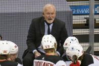 New Jersey Devils coach Lindy Ruff gives instructions during the first period of the team's NHL hockey game against the Pittsburgh Penguins in Pittsburgh, Thursday, April 22, 2021. (AP Photo/Gene J. Puskar)