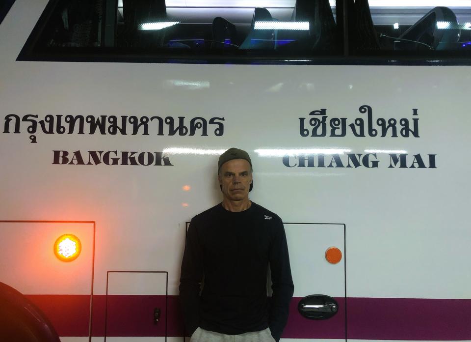 Author Brendan Sainsbury in front of a Thai bus