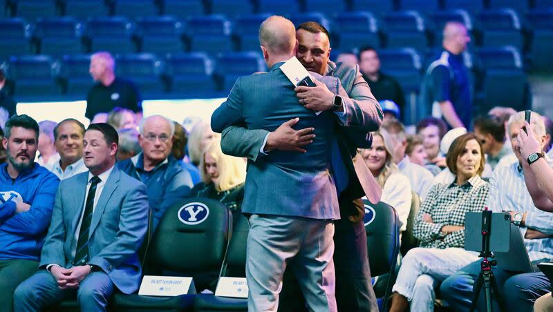 BYU’s new men’s head basketball coach Kevin Young and head football coach Kalani Sitake hug before the official announcement event in the Marriott Center in Provo on Wednesday, April 17, 2024.