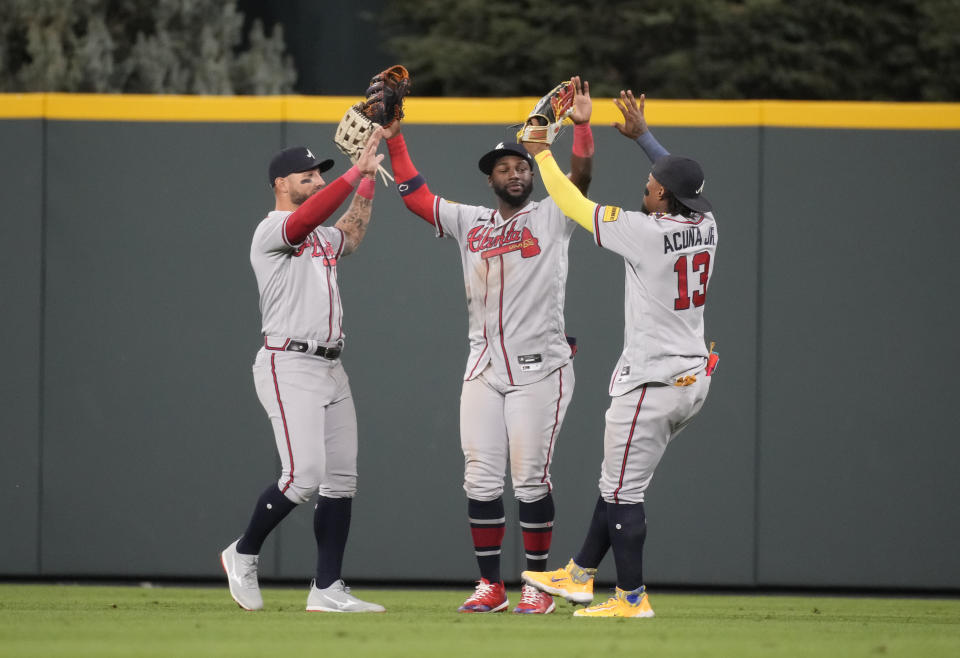 From left, Atlanta Braves left fielder Kevin Pillar, center fielder Michael Harris II and right fielder Ronald Acuna Jr. celebrate after a baseball game against the Colorado Rockies, Monday, Aug. 28, 2023, in Denver. (AP Photo/David Zalubowski)