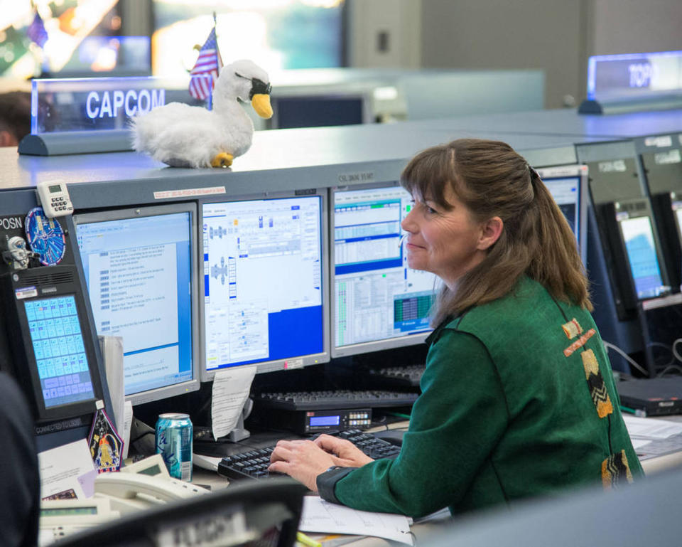 Inside the space station control room at Johnson Space Center's Mission Control Center, astronaut Cady Coleman, spacecraft communicator (CAPCOM), monitors communications during the grapple and unberthing of the Cygnus cargo ship from the International Space Station on Oct. 22, 2013. <cite>NASA</cite>