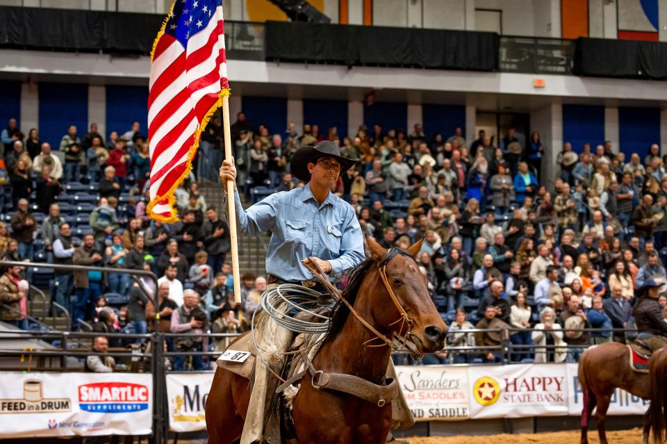 Top Hand from 2022 Logan Westcott carries the American flag in during the opeining ceremonies for the 2023 WRCA World Championship Ranch Rodeo. This has become a tradition for the top hand award winner to carry the flag each night. The rodeo continues at the Amarillo Civic Center through Sunday.