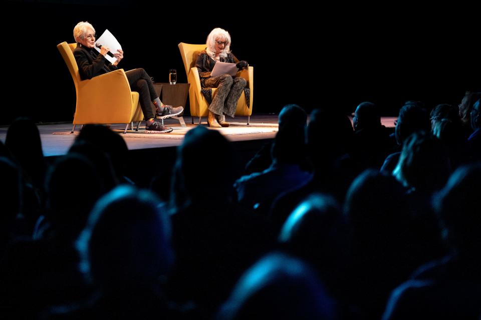 Joan Baez, left, speaks about new book of drawings, Am I Pretty When I Fly? An Album of Upside Down Drawings, with Emmylou Harris, right, at OZ Arts in Nashville, Tenn., Saturday, April 8, 2023.