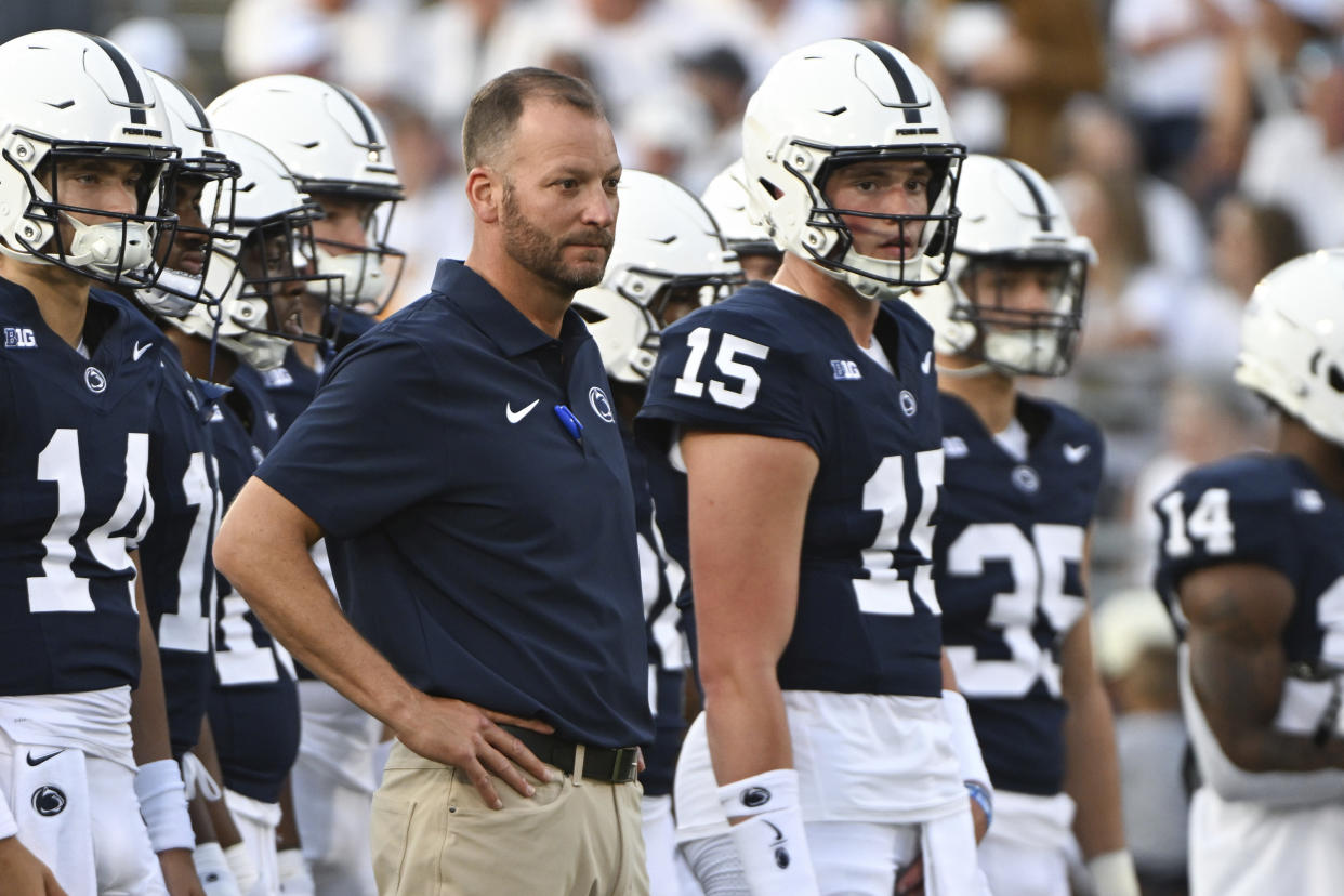 Penn State offensive coordinator Mike Yurcich and quarterback Drew Allar (15) watch pregame of an NCAA college football game, Saturday, Sept. 2, 2023, in State College, Pa. (AP Photo/Barry Reeger)
