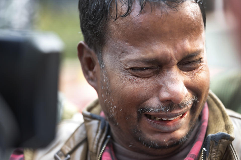 Mukhtar Alam, who lost his relative in a fire, cries as he waits for the body outside a mortuary in New Delhi, India, Sunday, Dec. 8, 2019. Dozens of people died on Sunday in a devastating fire at a building in a crowded grains market area in central New Delhi, police said. (AP Photo/Manish Swarup)