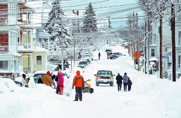 Residents of Palmer Street in Fall River dig out after a snowstorm in 2013.