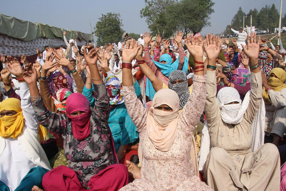 Women activists from Jat community raise their hands during their protest to demand for reservations in government jobs at Jassia village on Jan. 31, 2017 in Rohtak, India.