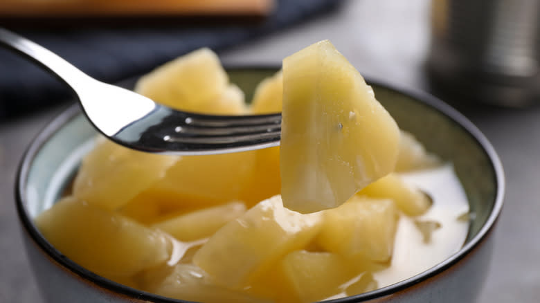 Canned pineapple on fork