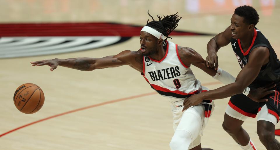 Portland Trail Blazers forward Jerami Grant, left, and Houston Rockets forward Jae'Sean Tate, right, battle for the ball during the first quarter of an NBA basketball game in Portland, Ore., Friday, Oct. 28, 2022. (AP Photo/Steve Dipaola)