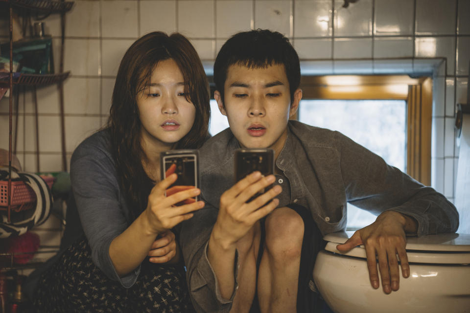 This image released by Neon shows So-dam Park, left, and Woo-sik Choi in a scene from "Parasite." (Neon via AP)