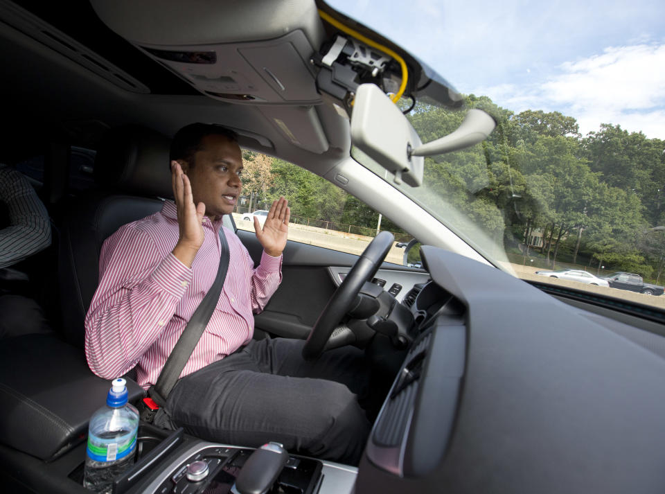 Kaushik Raghu, Senior Staff Engineer at Audi, takes his hands off the steering wheel while demonstrating an Audi self driving vehicle on I-395 expressway in Arlington, Va., Friday, July 15, 2016. Experts say the development of self-driving cars over the coming decade depends on an unreliable assumption by most automakers: that the humans in them will be ready to step in and take control if the car's systems fail. Experience with automation in other modes of transportation suggests that strategy will lead to more deaths like that of a Florida Tesla driver in May. (AP Photo/Pablo Martinez Monsivais)