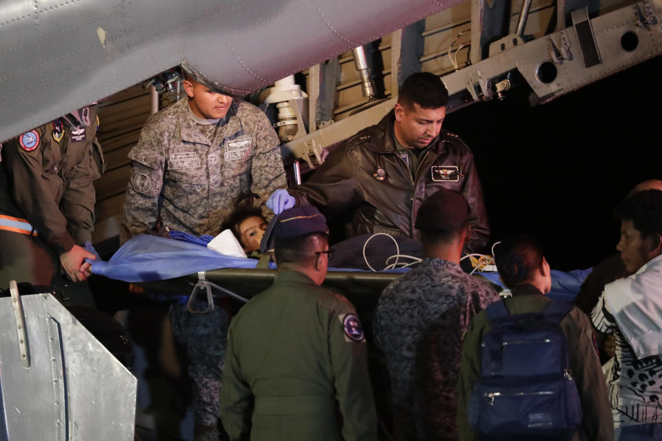 Military personnel unload from a plane one of four Indigenous children who were missing after a deadly plane crash at the military air base in Bogota, Colombia, Saturday, June 10, 2023. The children survived a small plane crash 40 days ago and had been the subject of an intense search in the jungle. (AP Photo/Ivan Valencia)
